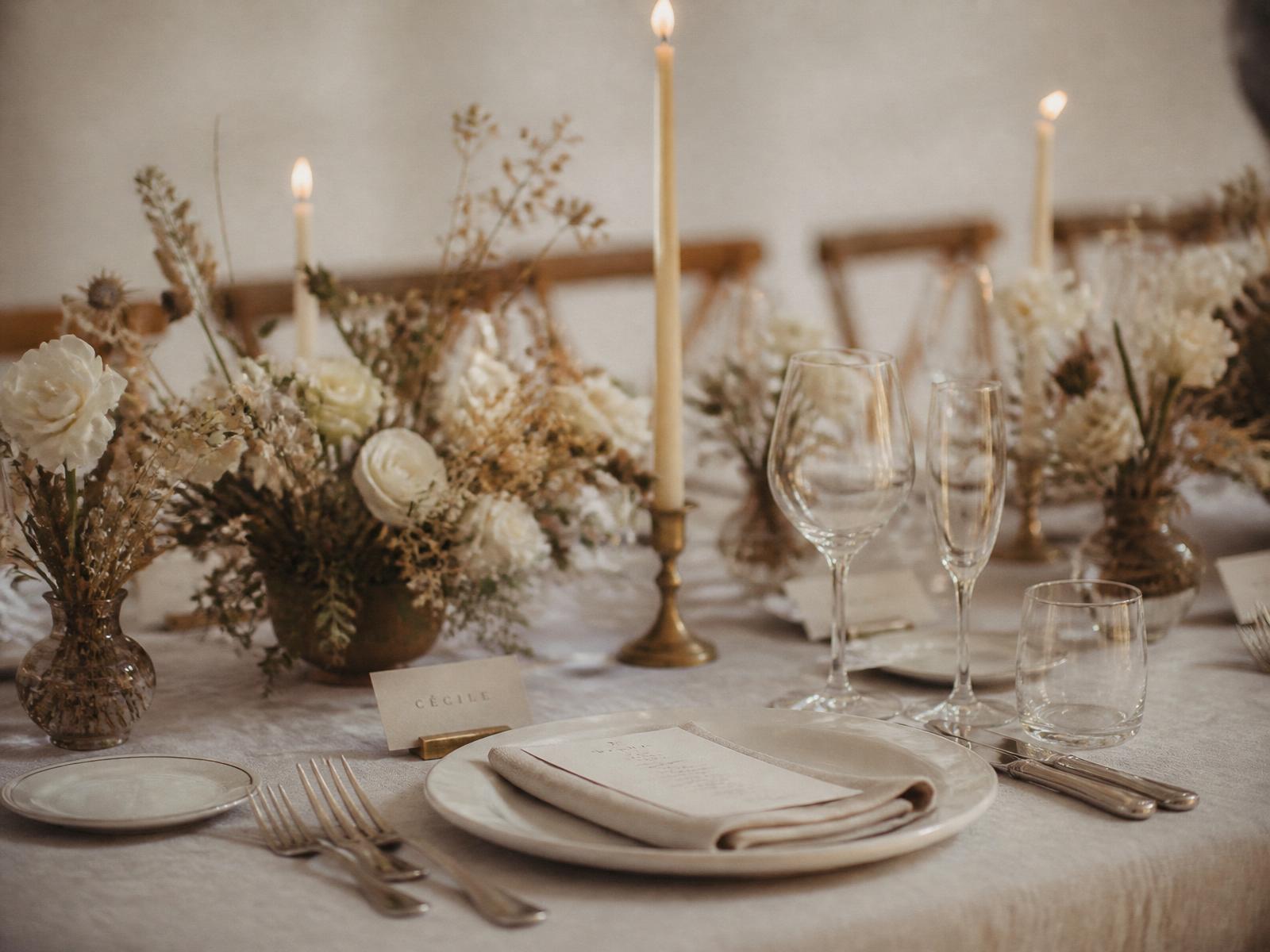 A table setting arranged with soft florals and paper stationery